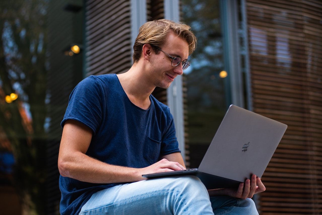 Man researching on Macbook laptop